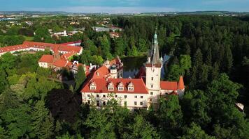 Aerial descending view of Pruhonice chateau with pond and park in May 2025 in Czechia video