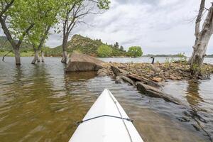 spring canoeing on Horsetooth Reservoir at foothills of Rocky Mountains near Fort Collins, Colorado - POV paddler perspective photo