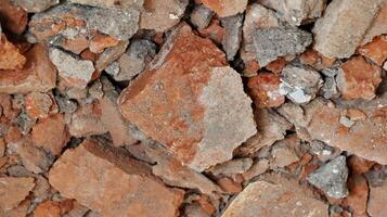 Concrete wall. destroyed, with lining from bits of broken brick. Used as a background. photo