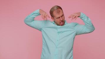 Funny joyful man making playful silly facial expressions, grimacing, fooling around showing tongue video