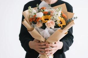 A person holding a bouquet of flowers, symbolizing greeting and celebration photo