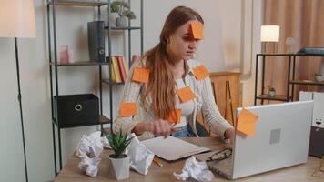 Exhausted woman freelancer with pasted stickers using laptop having concentration problem in office video