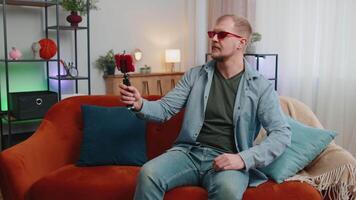 Man blogger influencer taking selfie on smartphone, make virtual social media online at home video