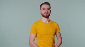 Bearded man smiling friendly at camera and waving hands gesturing hello or goodbye, welcoming video