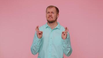 Stylish man in shirt shouting, raising fists in gesture I did it, celebrating success, winning video