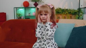 Displeased little teen child girl rubbing temples to cure headache problem, suffering from migraine video