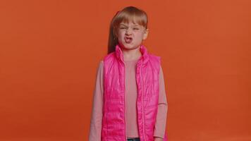 Funny joyful girl making playful silly facial expressions, grimacing, fooling around showing tongue video