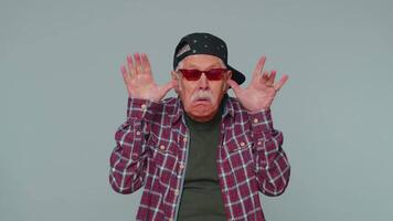 Funny joyful man making playful silly facial expressions, grimacing, fooling around showing tongue video