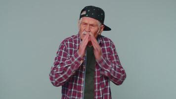 Senior man closing eyes with hand showing stop gesture, confused shy scared to watch, shame, shy video