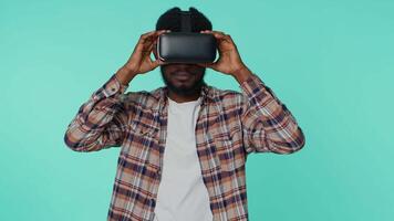Man using virtual reality futuristic technology VR headset helmet to play simulation 3D game video