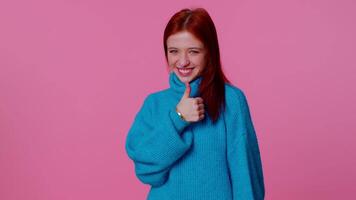 Smiling redhead happy girl blinking eye, looking at camera with toothy smile, winking and flirting video