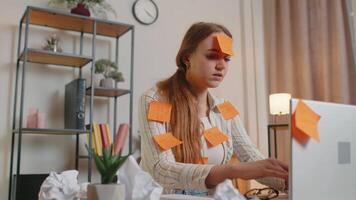 Exhausted woman freelancer with pasted stickers using laptop having concentration problem in office video