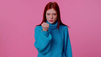 Aggressive angry girl trying to fight at camera, shaking fist, boxing with expression, punishment video