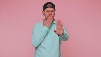 Frightened scared man closing his mouth gestures no, refusing to tell terrible secret, truth video