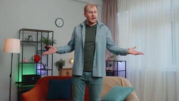 Upset poor man showing empty pockets inside out, having no money, bankruptcy, debts, poverty problem video