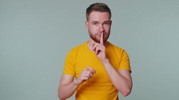 Man presses index finger to lips makes silence gesture sign do not tells secret, shh be quiet video