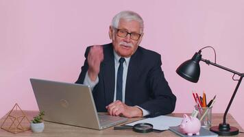 Upset senior businessman making face palm gesture, feeling bored, disappointed in result, bad news video