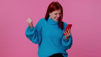 Happy excited girl use mobile phone say wow yes found out great big win news doing winner gesture video
