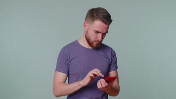 Tourist man using mobile phone typing post on web sms message browsing addiction of social networks video