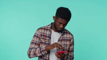 African american man use mobile phone typing post sms message browsing addiction of social networks video