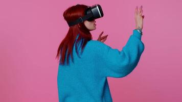Girl using virtual reality futuristic technology VR headset helmet to play simulation 3D game video