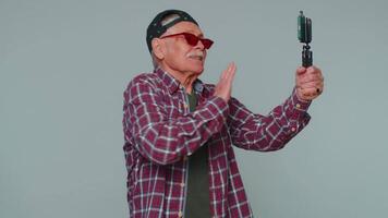Man blogger take selfie on mobile phone selfie stick communicate call online with subscribers video