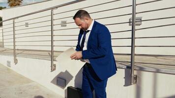 Business Man Working And Reading Outdoor With A Suitcase video
