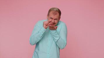 Man showing a little bit gesture with sceptic smile, showing minimum sign, measuring small size video