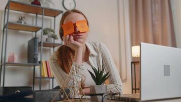 Tired woman teacher using laptop computer with funny stickers on eyes sleeps at workplace, napping video
