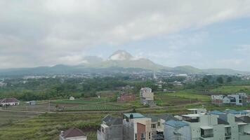 Breathtaking Panoramic View of Majestic Mountain Overlooking Verdant Fields and Charming Towns video