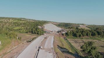 Aerial View of Undergoing Construction Site Surrounded by Lush Greenery and Hills video
