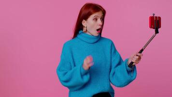 Adult girl blogger taking selfie on mobile phone, communicating call online with subscribers video
