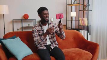 Man blogger influencer taking selfie on smartphone, make virtual social media online at home video