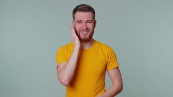 Man touching cheek suffering from toothache cavities or gingivitis waiting for dentist appointment video