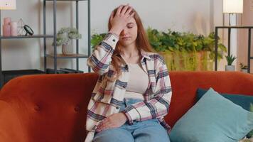 Upset young woman making face palm gesture, feeling bored, disappointed, bad news shame mistake video