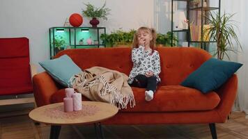Little tired lazy sleeping children girl lying asleep on sofa feeling lack of energy at home alone video