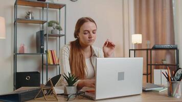 Tired woman teacher using laptop computer with funny stickers on eyes sleeps at workplace, napping video
