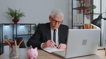 Cheerful senior mature business office man wears glasses, formal suit, smiling, looking at camera video