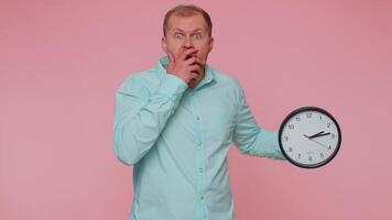 Confused man with anxiety checking time on clock, running late to work, being in delay, deadline video