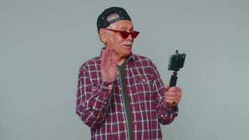 Man blogger take selfie on mobile phone selfie stick communicate call online with subscribers video