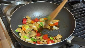 A vibrant stir fry with colorful vegetables being cooked in a pan, showcasing healthy eating, culinary arts, and home cooking, highlighting Asian cuisine and sauteing techniques video