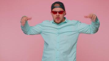 Funny joyful man making playful silly facial expressions, grimacing, fooling around showing tongue video