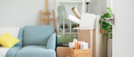 Moving house, relocation. inserted into the door of the new house, inside the room was a cardboard box containing personal belongings and furniture. move in the apartment or condominium photo