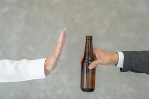 refuses say no and avoid to drink an alcohol, hand show reject and stopping, alcoholism treatment, alcohol addiction, quit booze, Stop Drinking Alcohol. Refuse bottle liquor, unhealthy photo