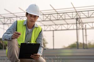 inspector or engineer is inspecting construction house using a checklist. Engineers and architects or contactor count materials for construction. Building, check, quality, foreman. photo