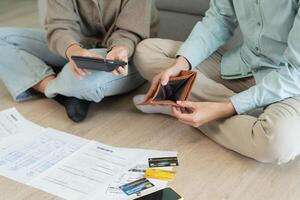 Stressed and headache asian couple with large bills or invoices no money to pay to expenses and business problem. shortage, Financial problems, mortgage, loan, bankruptcy, bankrupt photo