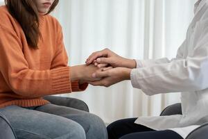 psychiatrist hold hand support each while discussing family issues. doctor encourages and empathy woman suffers depression. psychological, save divorce, Hand in hand together, trust, photo