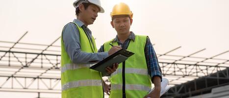 inspector or engineer is inspecting construction and quality assurance new house. Engineers or architects or contactor work to build the house before handing it over to the homeowner, photo