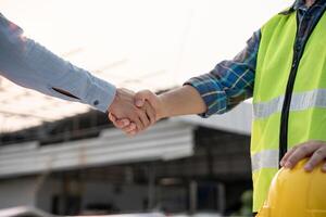 team hands shaking greeting start up plan new project contract in office center at construction site, industry ,architecture, partner, teamwork, photo