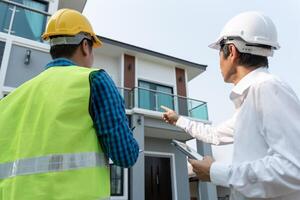 owner project is inspect construction and quality assurance new house. Engineers or architects or contactor work to build the house before handing it over to the homeowner photo